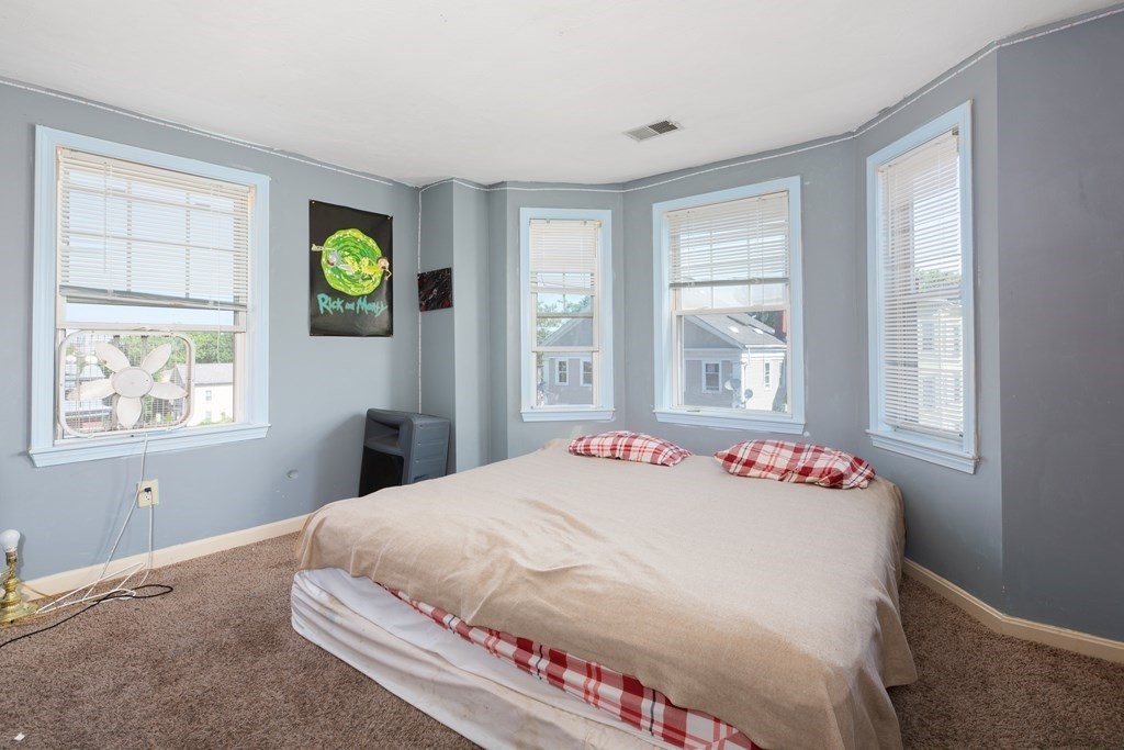 33 Forest Street Boston, MA 02119 - Photo 8 of 23 a bedroom with a bed window and table