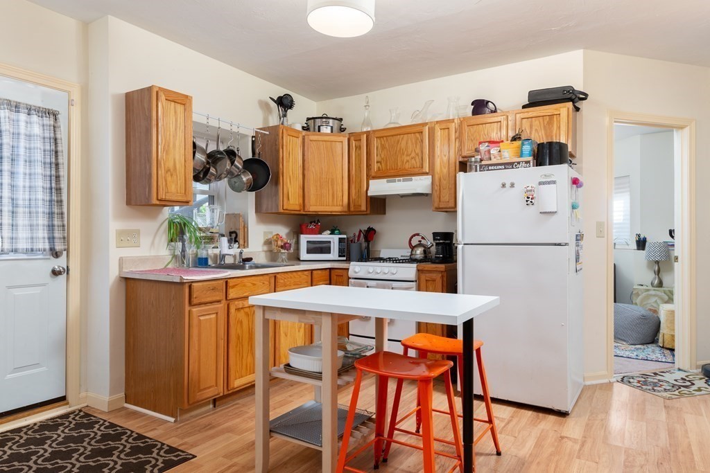 33 Forest Street Boston, MA 02119 - Photo 9 of 23 a kitchen with stainless steel appliances a refrigerator and a stove top oven