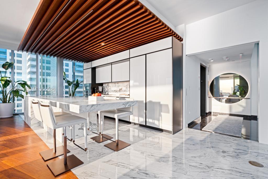 1300 Monad Terrace, Unit 12F Miami Beach, FL 33139 - Photo 9 of 24 a dining room filled with furniture and a large window