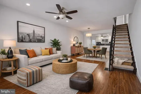 a living room with furniture and wooden floor