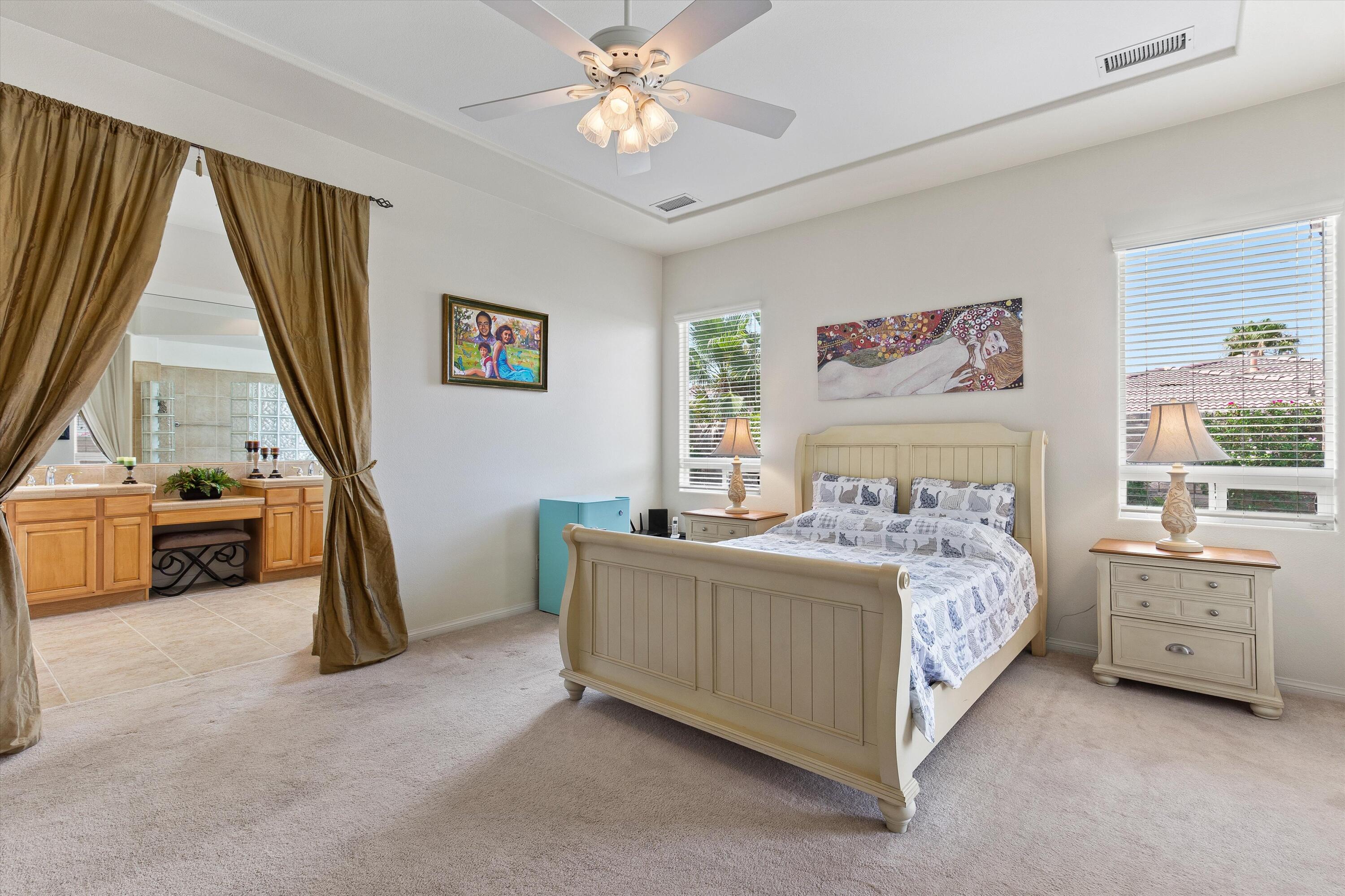 27 Via Del Maricale Rancho Mirage, CA 92270 - Photo 23 of 52 a bedroom with a bed and a window