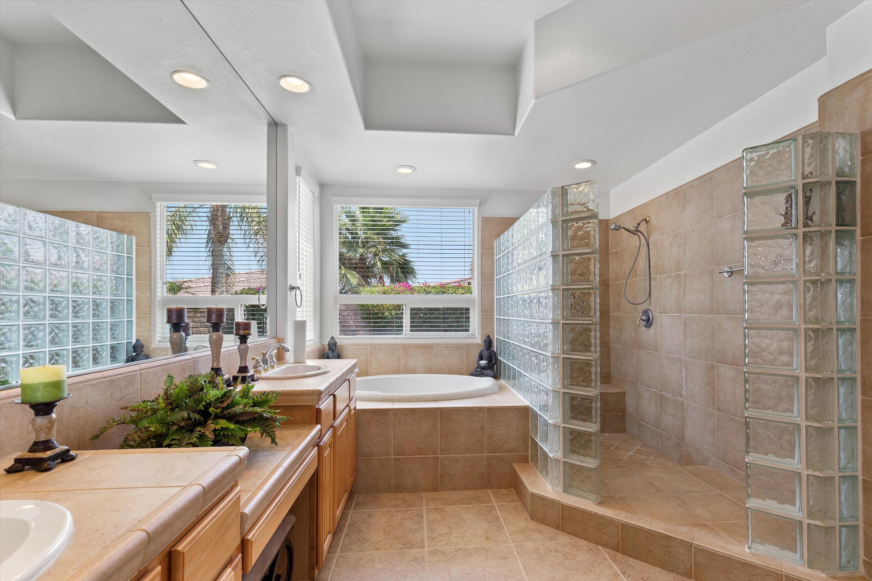 27 Via Del Maricale Rancho Mirage, CA 92270 - Photo 25 of 52 a large spacious bathroom with a tub shower and windows