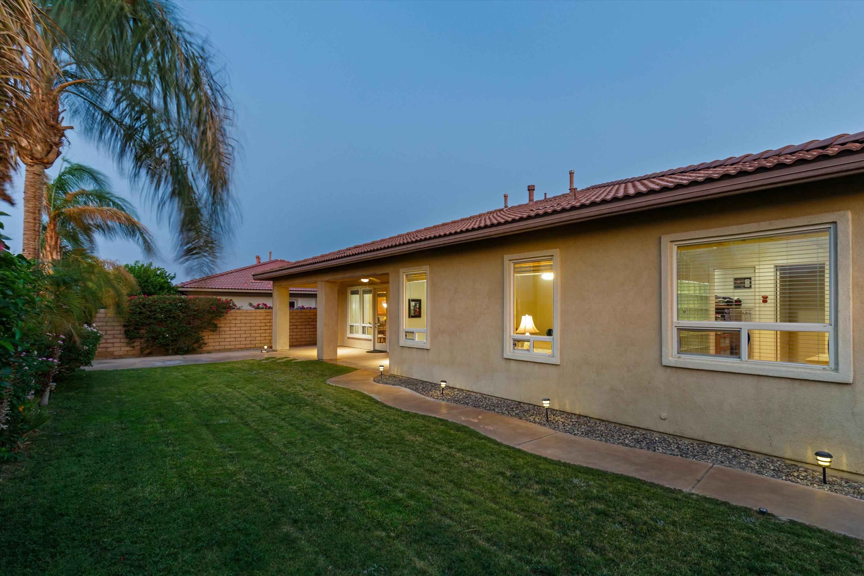 27 Via Del Maricale Rancho Mirage, CA 92270 - Photo 33 of 52 a backyard of a house with lots of green space