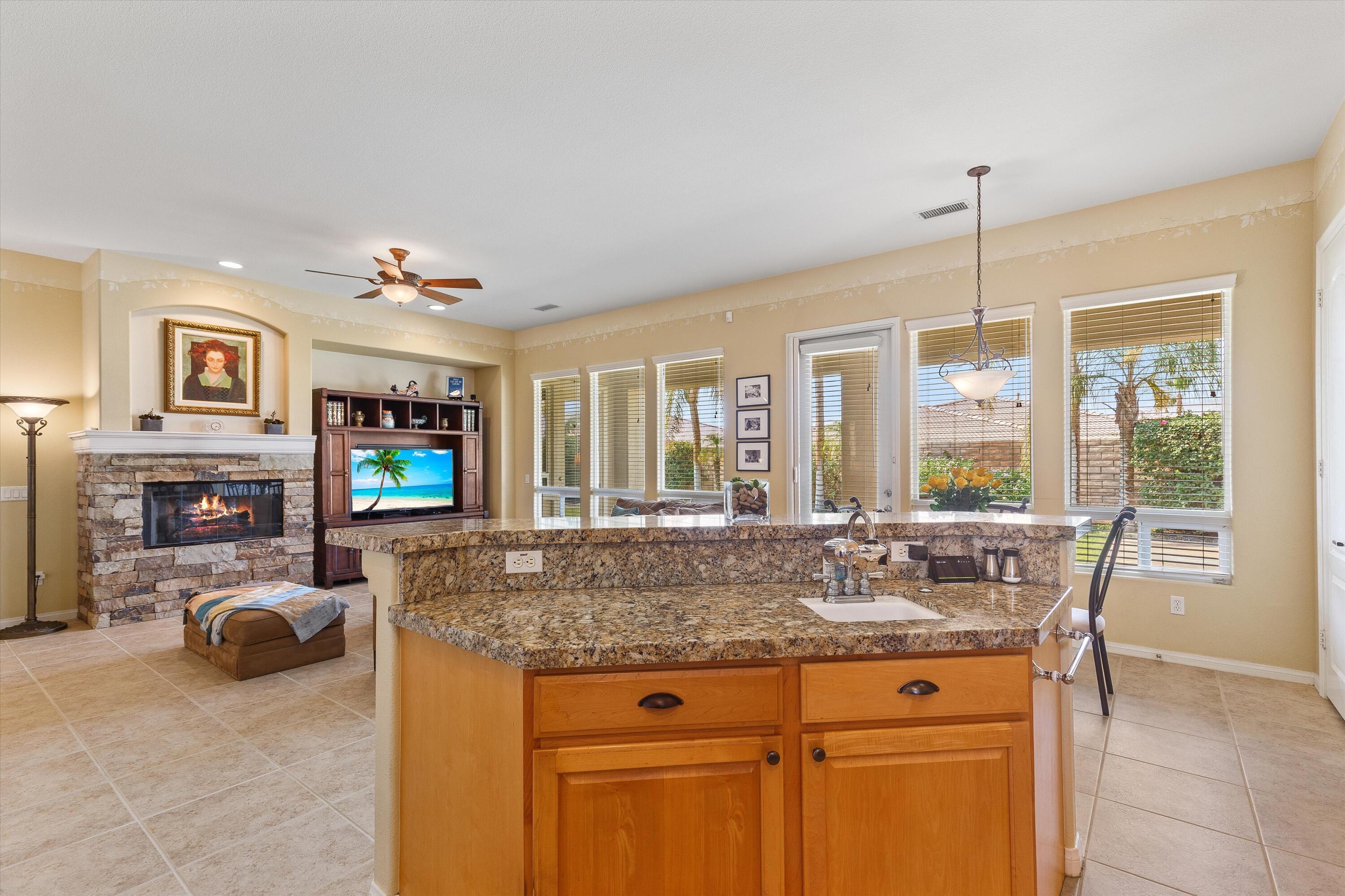 27 Via Del Maricale Rancho Mirage, CA 92270 - Photo 7 of 52 a view of living room with granite countertop furniture and fireplace