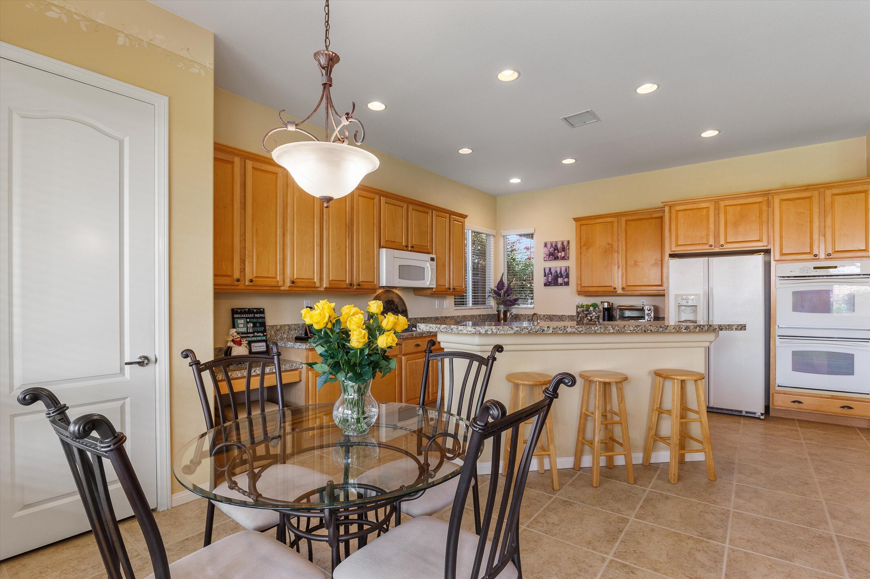 27 Via Del Maricale Rancho Mirage, CA 92270 - Photo 8 of 52 a dining room filled counter top space and a chandelier