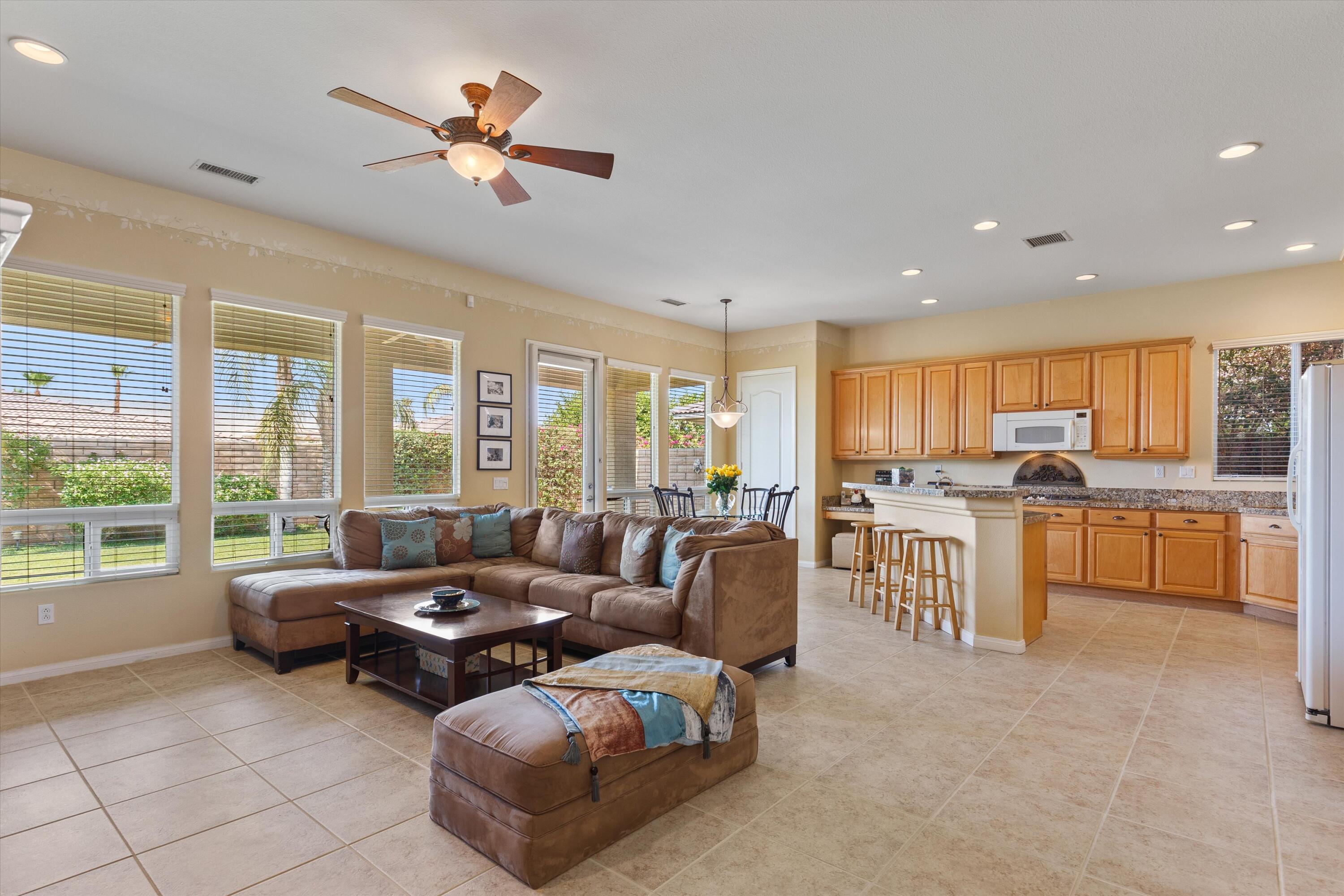 27 Via Del Maricale Rancho Mirage, CA 92270 - Photo 9 of 52 a living room with furniture and a large window with kitchen view