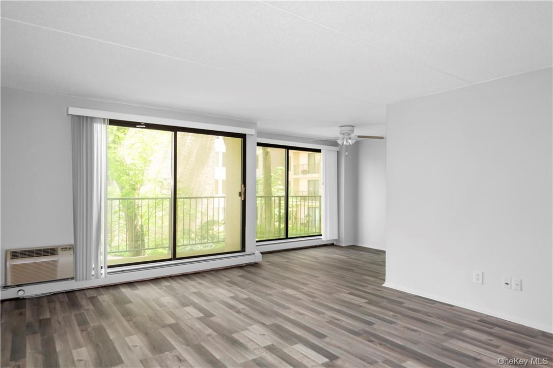 150 Overlook Avenue, Unit 2K Peekskill, NY 10566 - Photo 4 of 26 a view of an empty room with wooden floor and a window