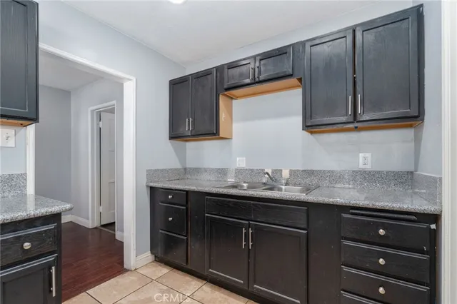 a kitchen with granite countertop a sink and a stove