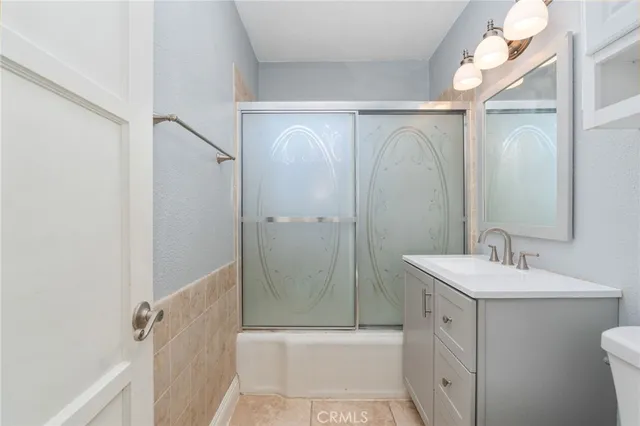 a bathroom with a sink a mirror and a shower