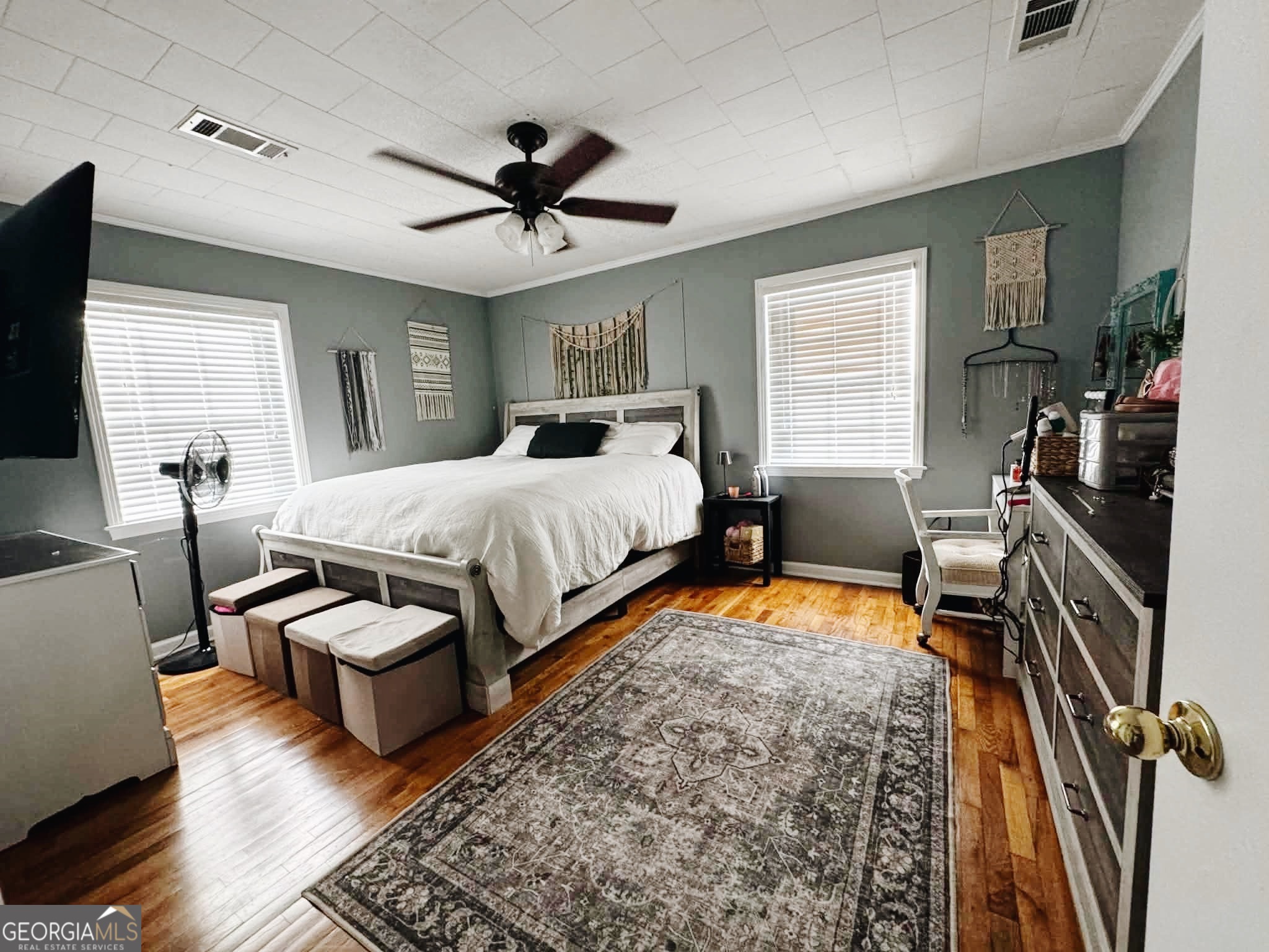 406 West 3rd Street Vidalia, GA 30474 - Photo 4 of 10 a bedroom with a bed and wooden floor