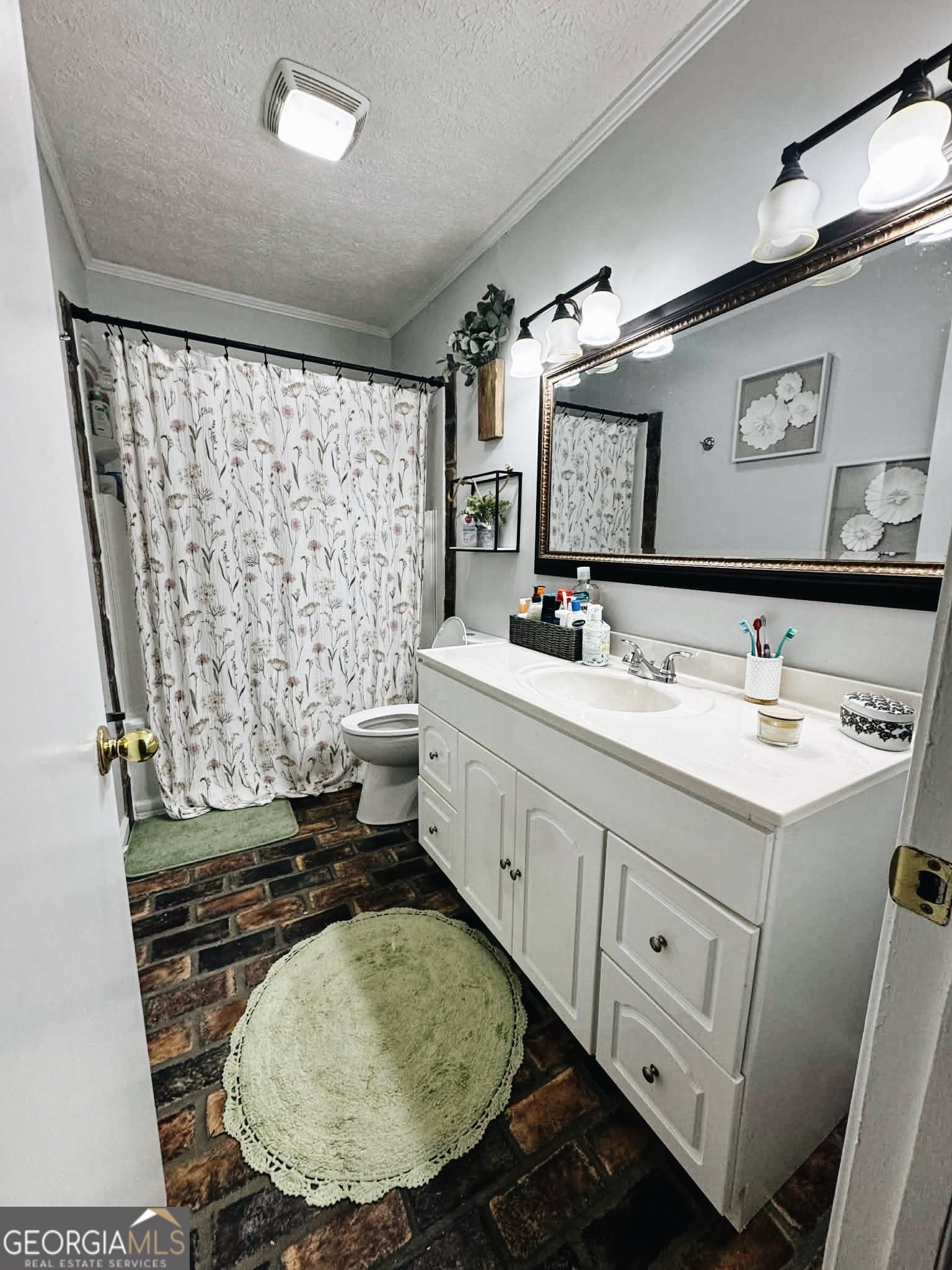 406 West 3rd Street Vidalia, GA 30474 - Photo 6 of 10 a bathroom with a double vanity sink mirror and shower