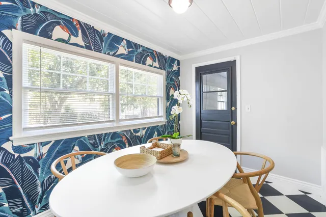 a view of a dining room with furniture and window