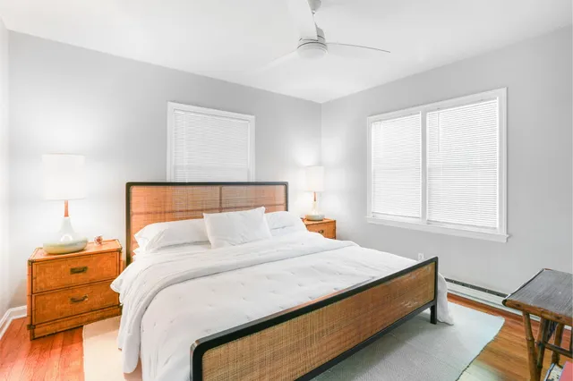 a bedroom with a bed and wooden floor