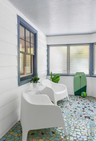 a bathroom with a window sink and mirror