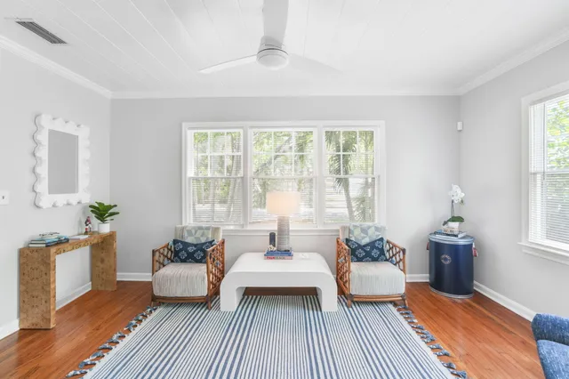 a spacious bedroom with a bed and wooden floor
