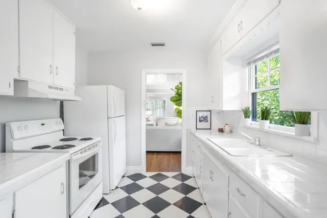 a kitchen with a sink stove and refrigerator