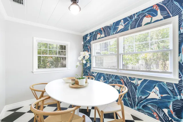 a view of a dining room with furniture and windows