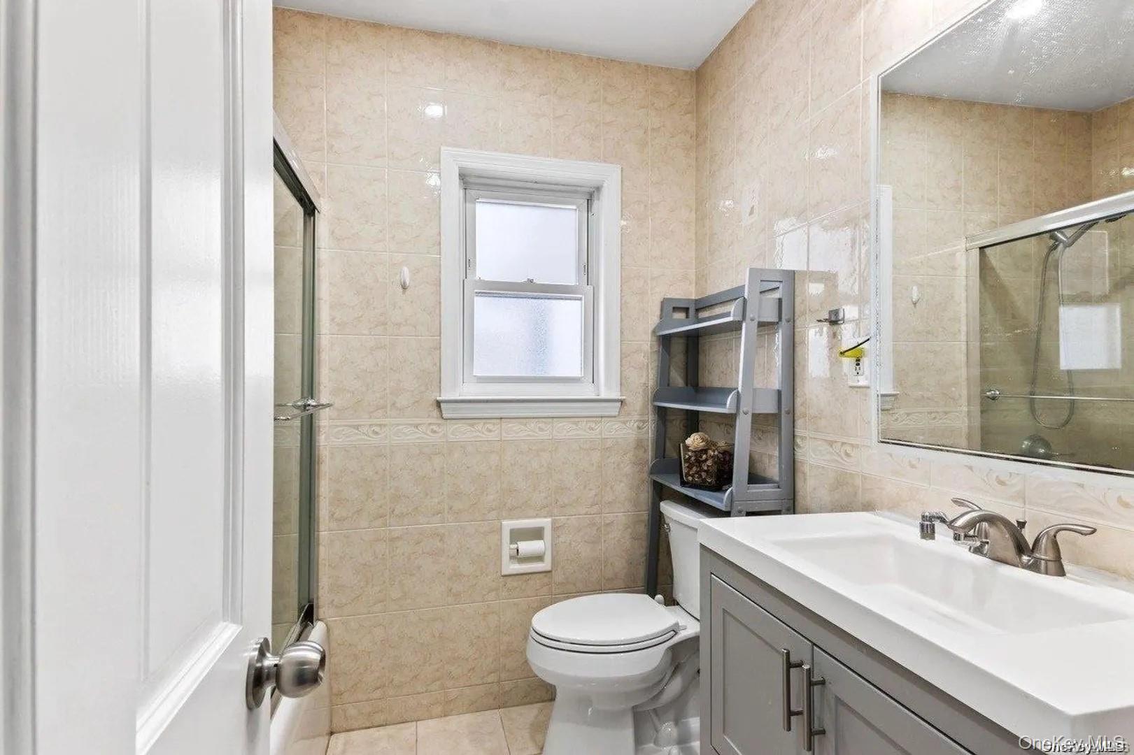 30 Aberdeen Road New Hyde Park, NY 11040 - Photo 4 of 37 a bathroom with a sink toilet vanity and shower