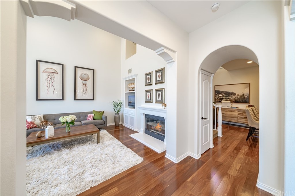 37 Mandria Newport Coast, CA 92657 - Photo 5 of 53 Living Room with fireplace and two story light filled ceilings.