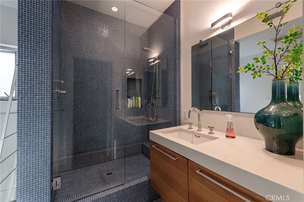 121 16th Street Manhattan Beach, CA 90266 - Photo 36 of 39 a bathroom with a sink and a mirror