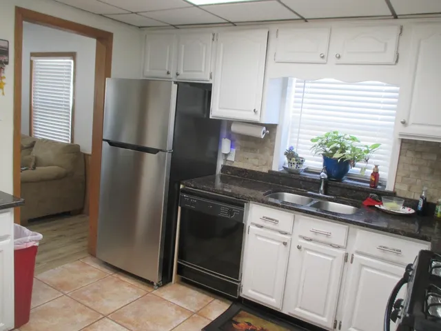 a kitchen with a refrigerator and cabinets
