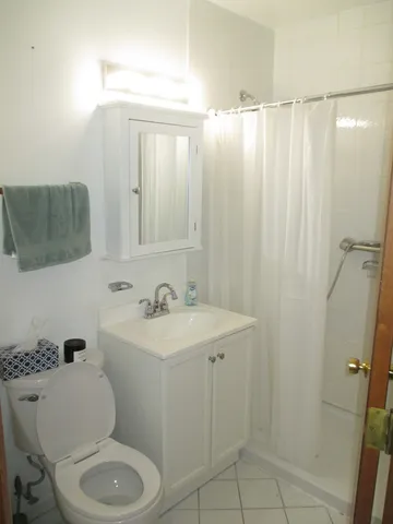 a bathroom with a toilet a sink and a shower