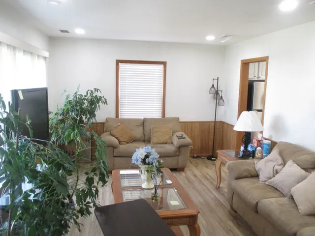 a living room with furniture and a potted plant