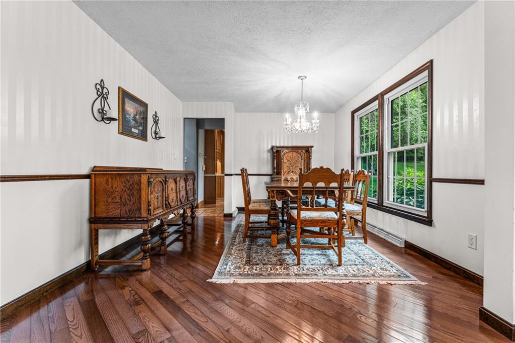 171 East Airport Road Butler, PA 16002 - Photo 17 of 47 a dining room with furniture a chandelier and wooden floor