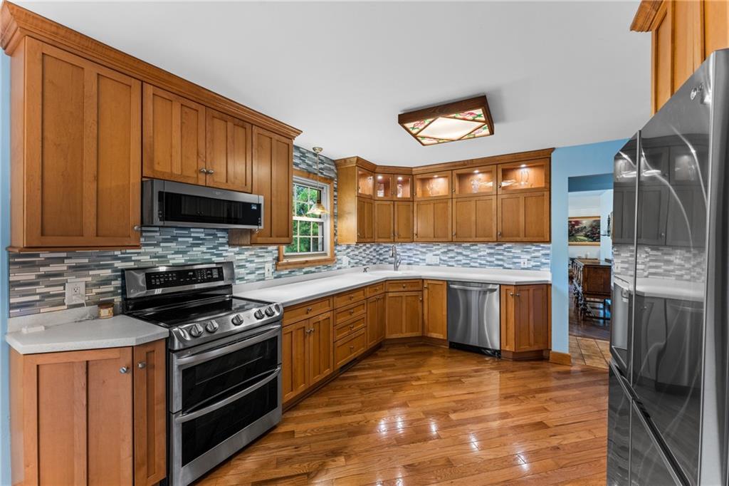 171 East Airport Road Butler, PA 16002 - Photo 24 of 47 a large kitchen with stainless steel appliances granite countertop a stove microwave and refrigerator