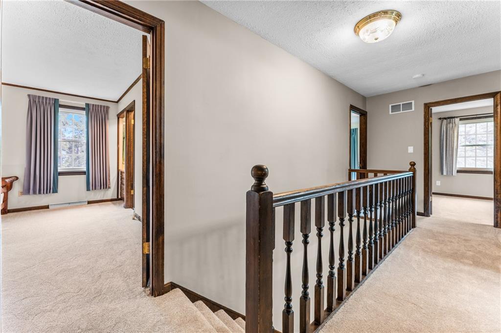 171 East Airport Road Butler, PA 16002 - Photo 38 of 47 a view of a hallway to a livingroom with wooden floor and staircase