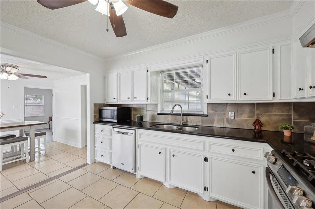 253 Hampton Lane Beaumont, TX 77707 - Photo 11 of 33 a kitchen with white cabinets and appliances