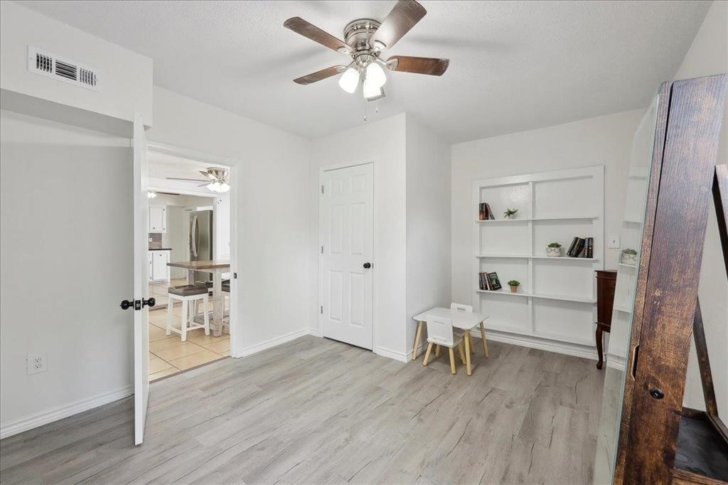 253 Hampton Lane Beaumont, TX 77707 - Photo 16 of 33 a view of a livingroom with furniture wooden floor a ceiling fan and windows