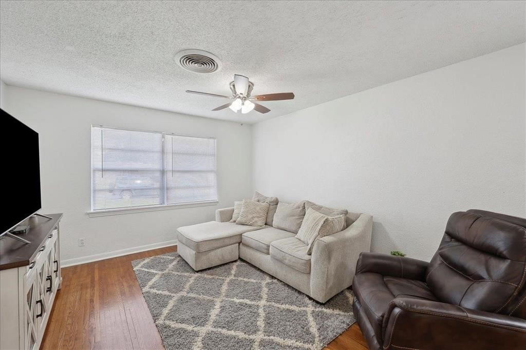 253 Hampton Lane Beaumont, TX 77707 - Photo 2 of 33 a living room with furniture a ceiling fan and a rug