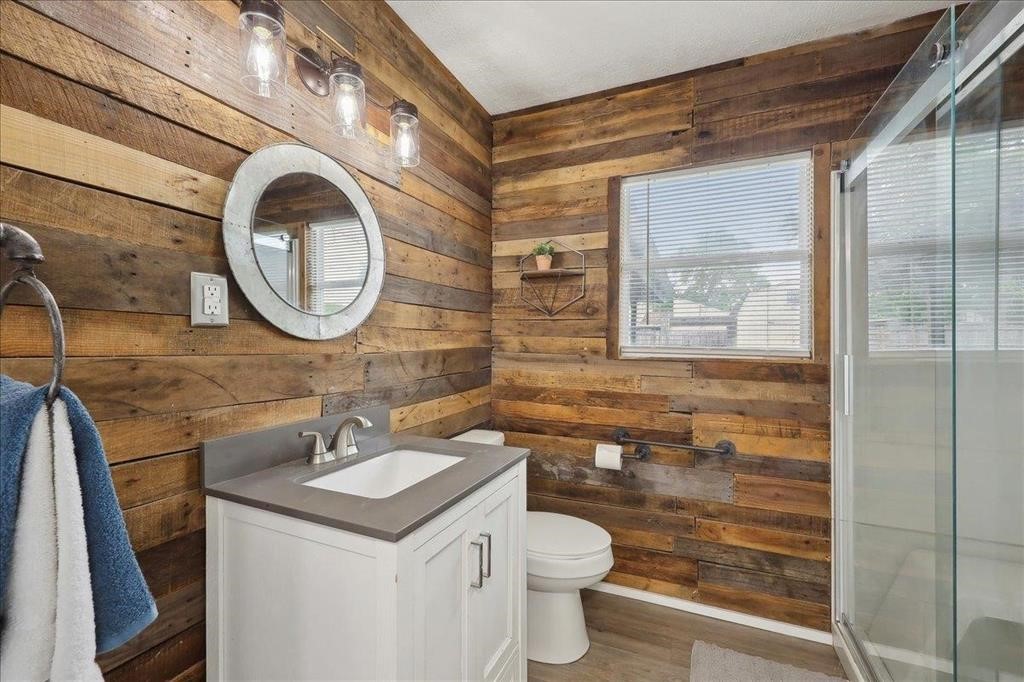 253 Hampton Lane Beaumont, TX 77707 - Photo 22 of 33 a bathroom with a sink a toilet and a mirror
