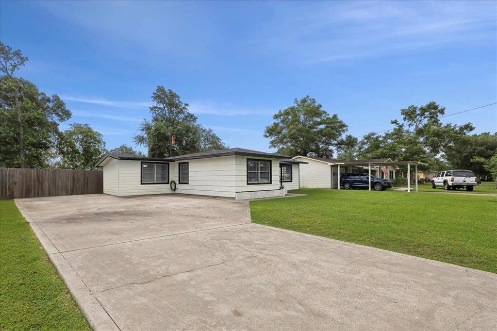 253 Hampton Lane Beaumont, TX 77707 - Photo 32 of 33 a front view of a house with a yard and trees