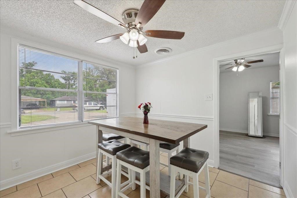 253 Hampton Lane Beaumont, TX 77707 - Photo 7 of 33 a dining room with chandelier fan and wooden floor