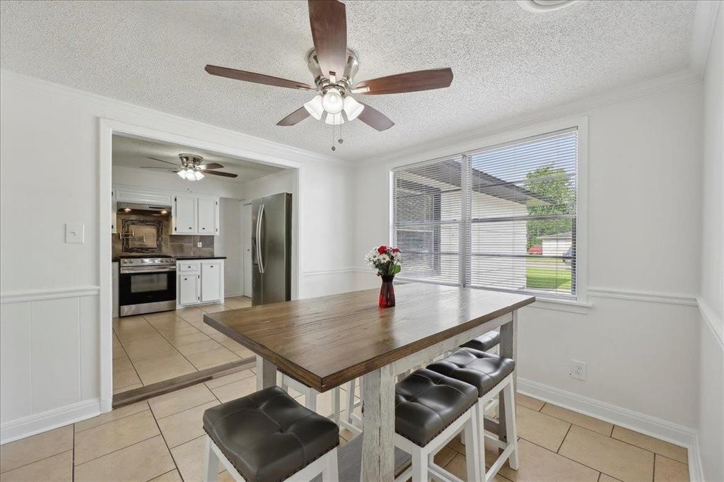 253 Hampton Lane Beaumont, TX 77707 - Photo 8 of 33 a view of a dining table chairs and chandelier