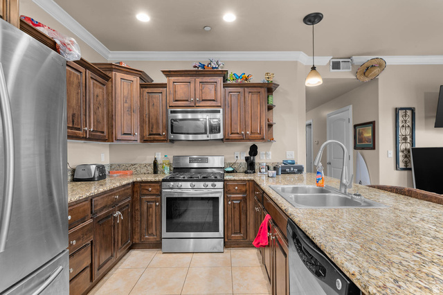 476 West 200 N Street, Unit 206 Springville, UT 84663 - Photo 7 of 24 Kitchen with stainless steel appliances, open shelves, crown molding, decorative light fixtures, and a peninsula