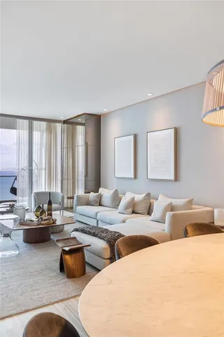 a living room with furniture and large windows