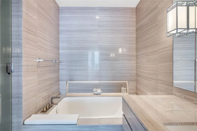 a bathroom with a bathtub and shower