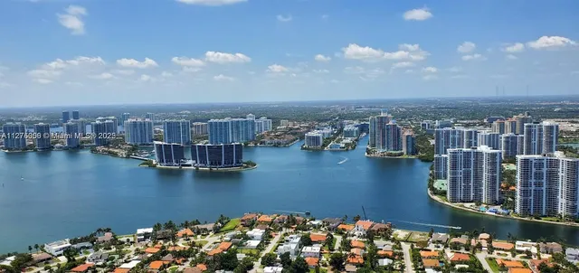 a bedroom with two beds and a large mirror with potted plant