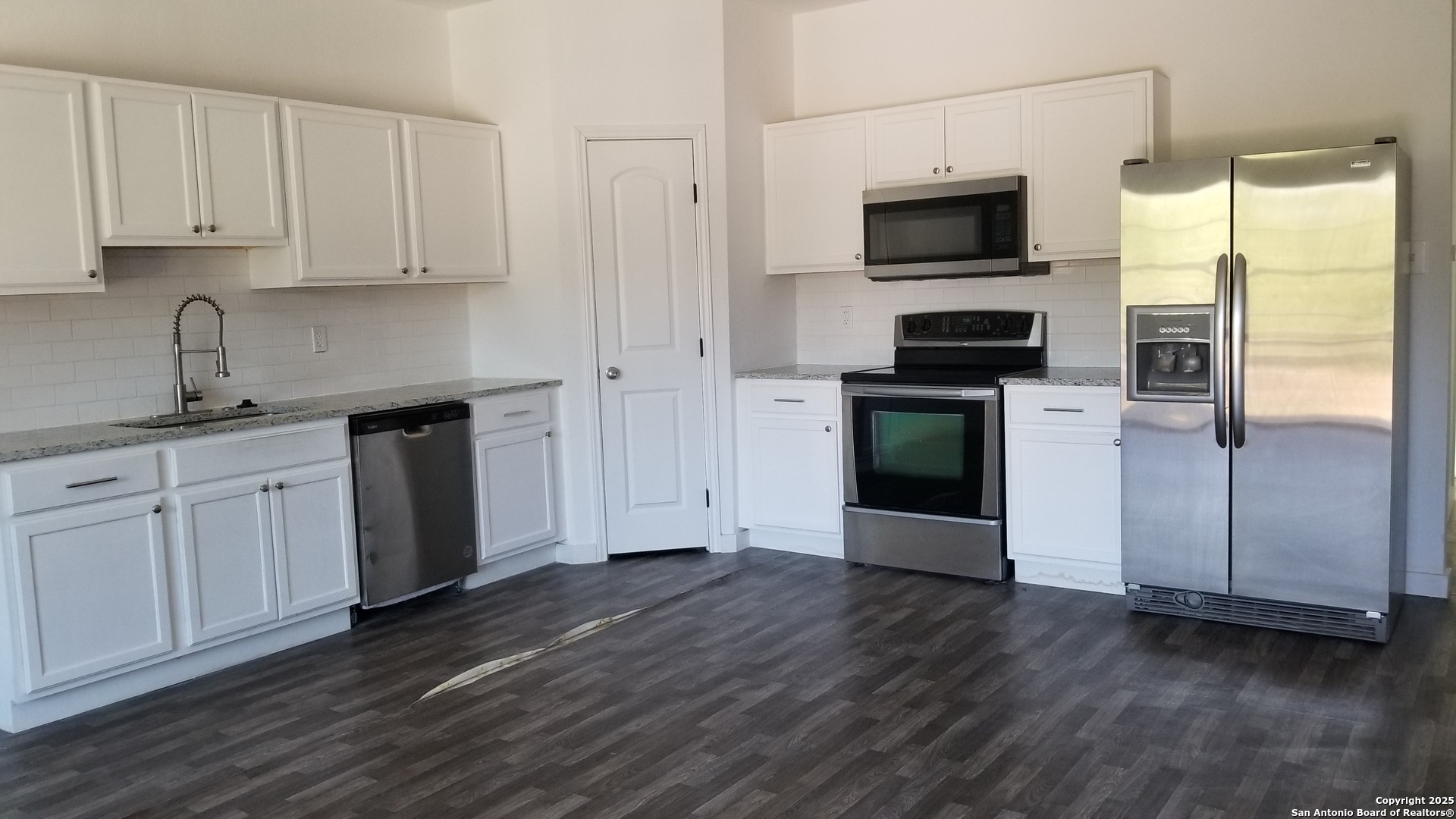1063 Sleepy Spring Branch, TX 78070 - Photo 3 of 14 a kitchen with a sink wooden floor and stainless steel appliances