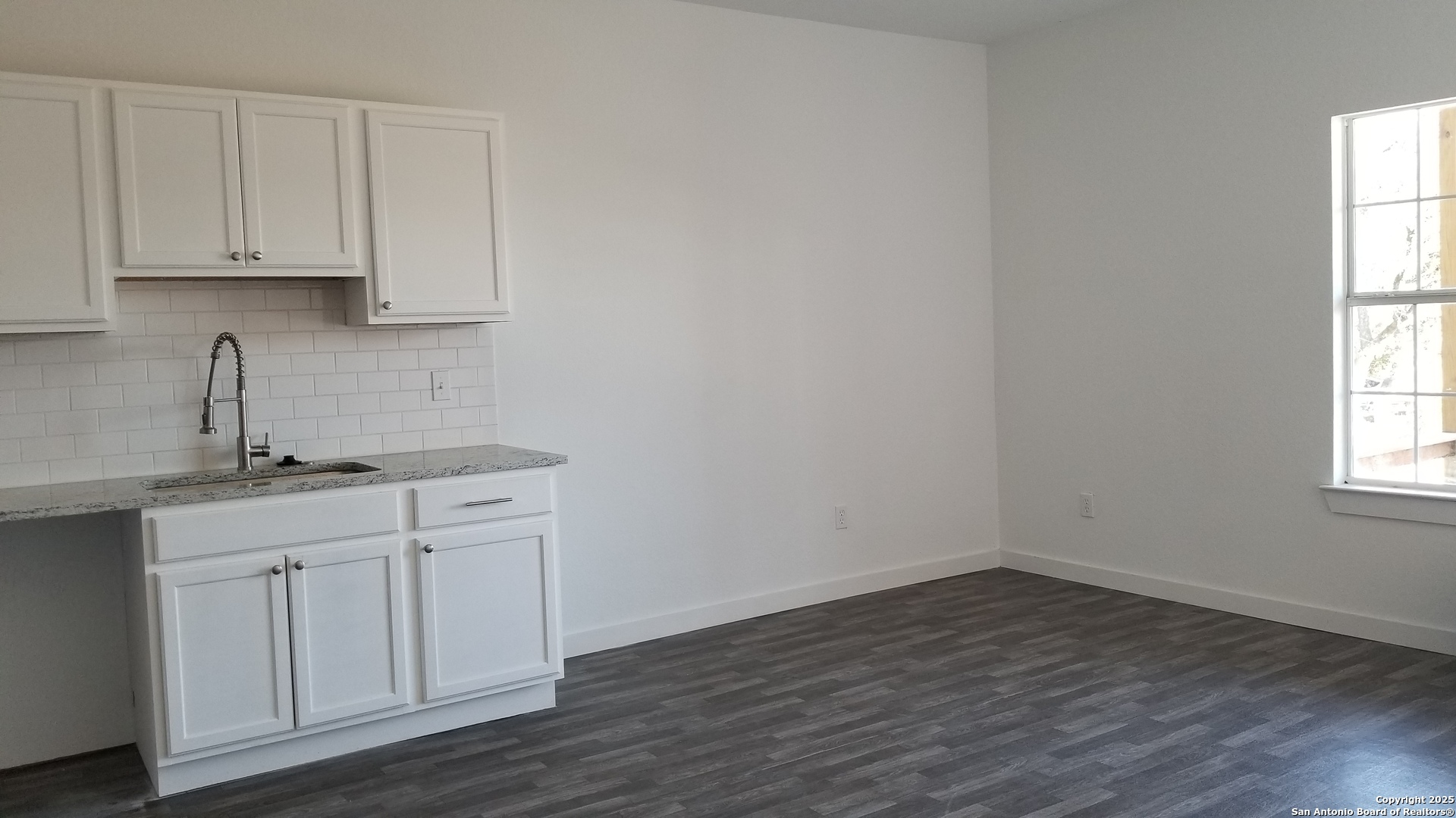 1063 Sleepy Spring Branch, TX 78070 - Photo 4 of 14 a kitchen with a sink cabinets and a window