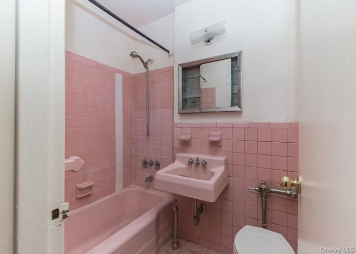 5235 Post Road, Unit 1B Bronx, NY 10471 - Photo 20 of 20 a bathroom with a sink toilet a mirror and shower