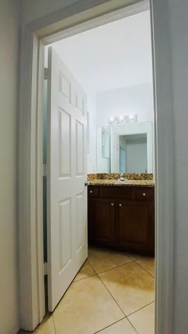 a front view of a house with a yard and garden