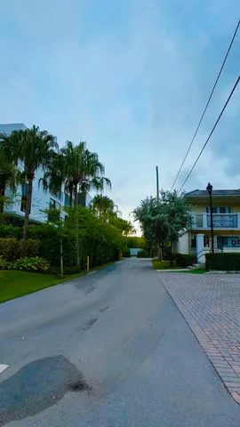 a front view of multi story residential apartment building with yard and sign board