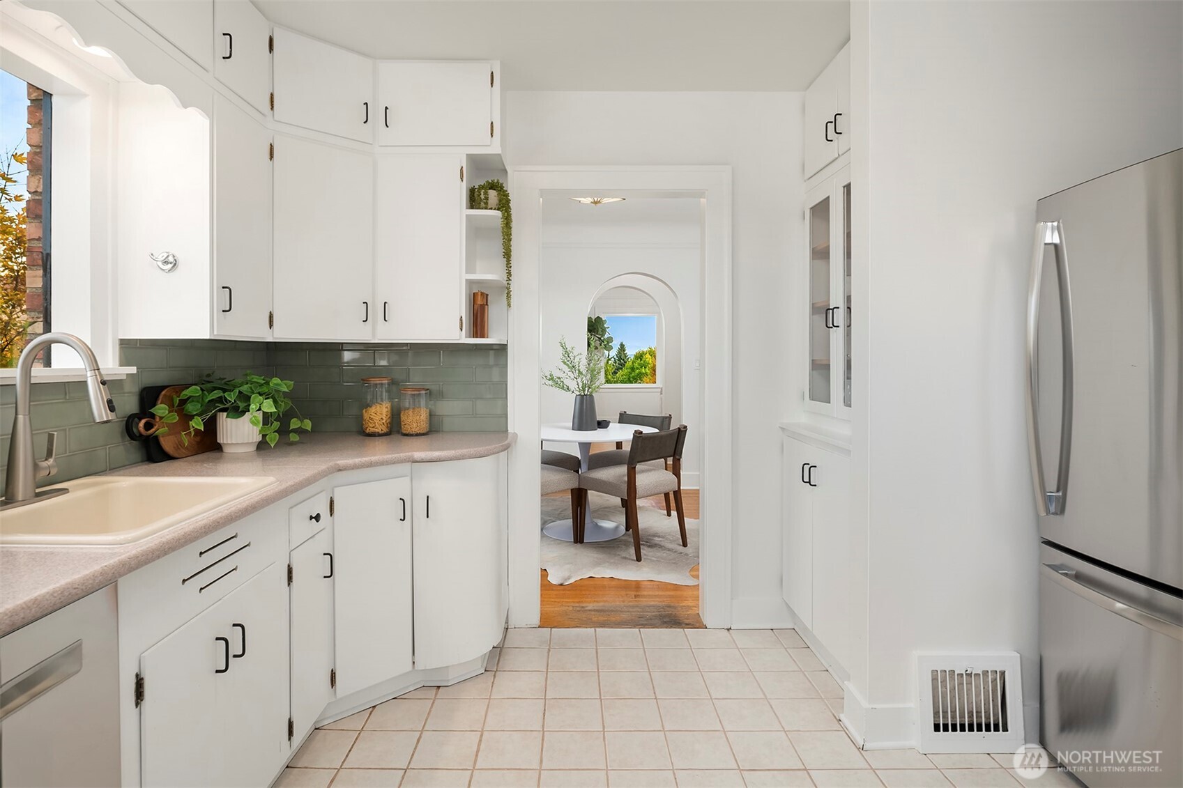 2503 37th Avenue West Seattle, WA 98199 - Photo 12 of 36 a kitchen with white cabinets and refrigerator