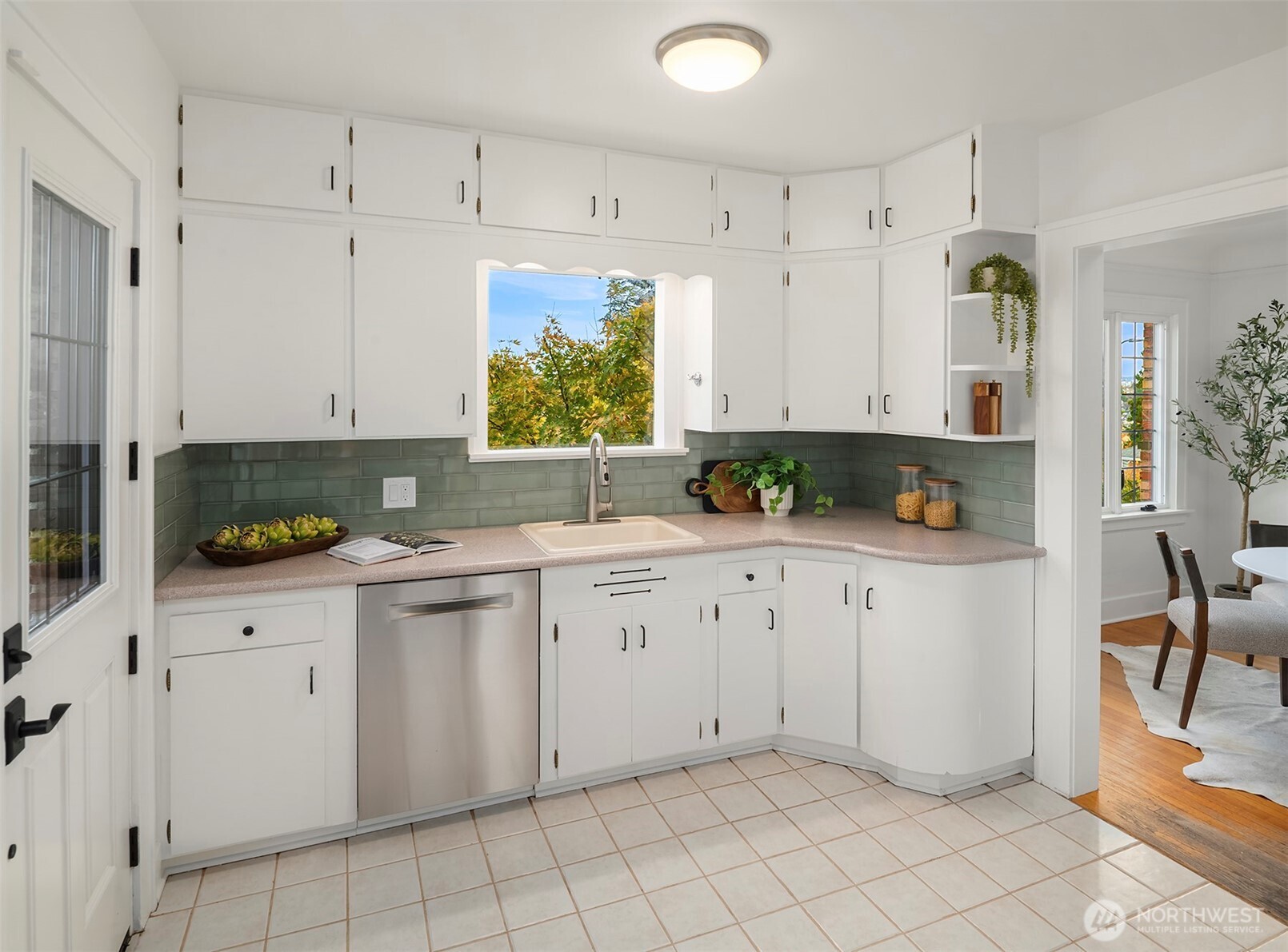 2503 37th Avenue West Seattle, WA 98199 - Photo 14 of 36 a kitchen with white cabinets and white appliances