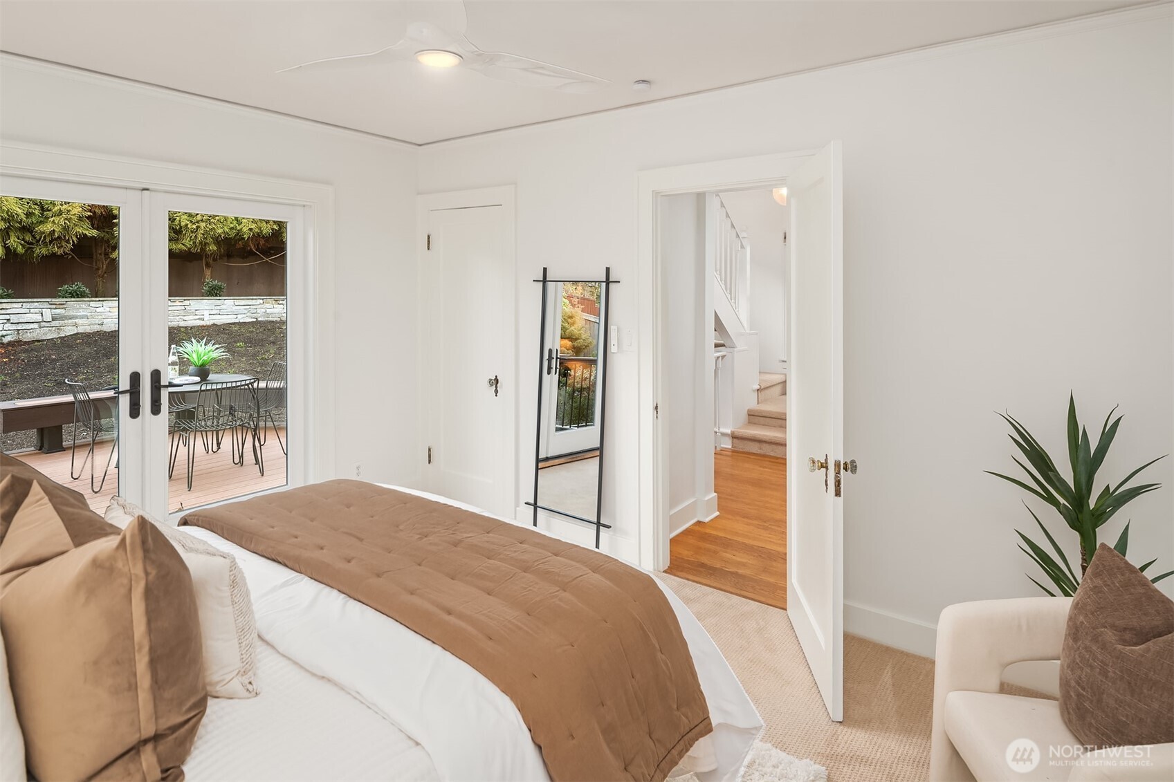 2503 37th Avenue West Seattle, WA 98199 - Photo 17 of 36 a bedroom with a bed and glass windows
