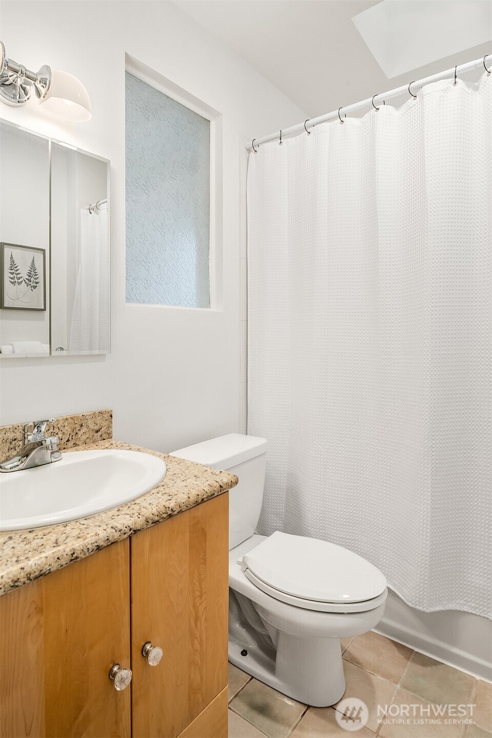 2503 37th Avenue West Seattle, WA 98199 - Photo 18 of 36 a bathroom with a granite countertop sink and a mirror